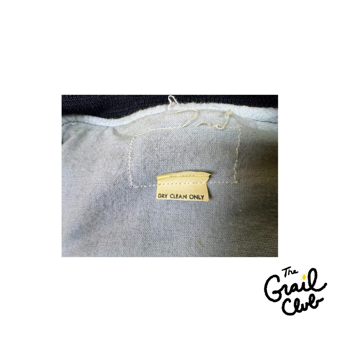 Fabric with a 'Dry Clean Only' label and The Grail Club logo.