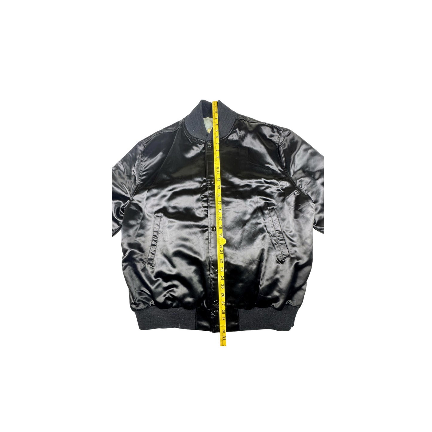 Black bomber jacket with a yellow measuring tape on a white background
