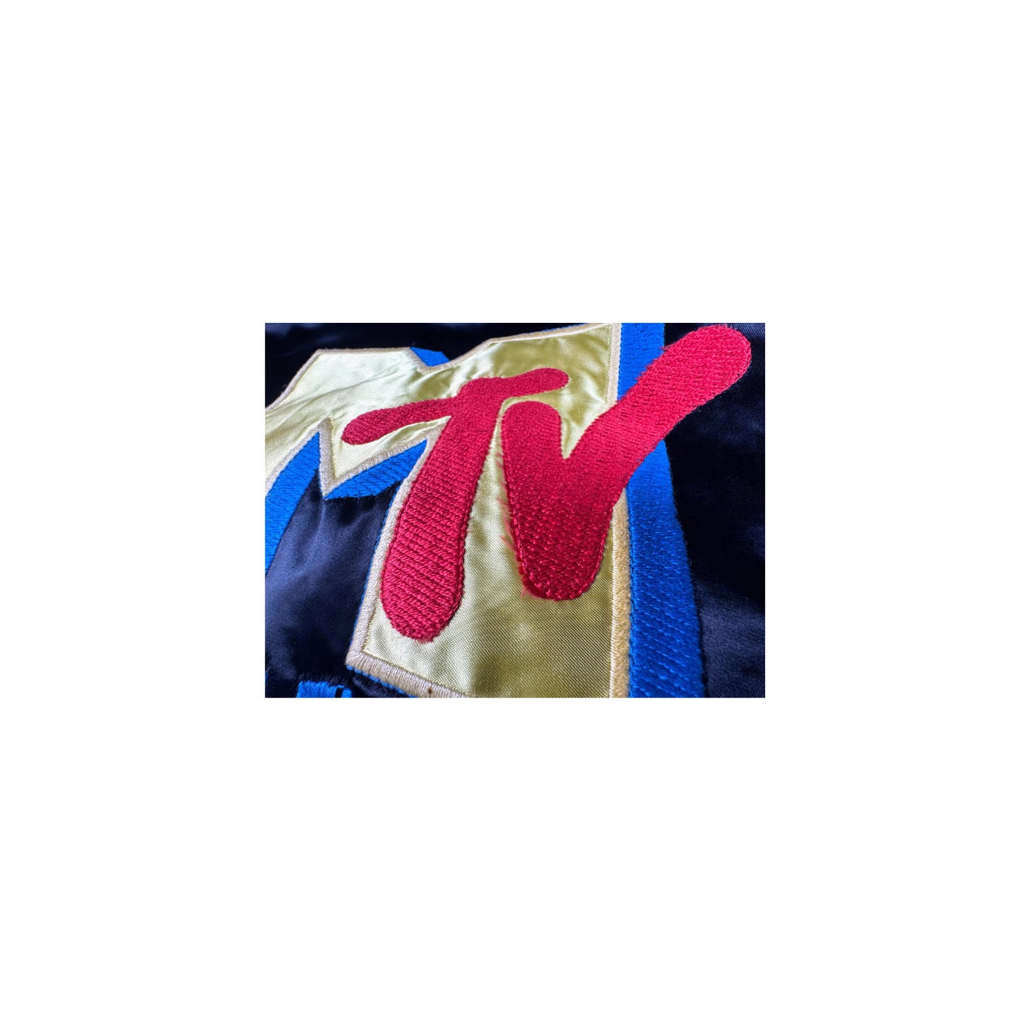 Close-up of a jacket with the MTV logo on a white background